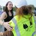 18-year-old Freida Steiner, of Ann Arbor, smiles as she reaches out to hug Camp Take Notice resident Dory Boston during a rally along Wagner Road in support of Camp Take Notice as a means to promote awareness and raise funds for the camp on Thursday.  Melanie Maxwell I AnnArbor.com